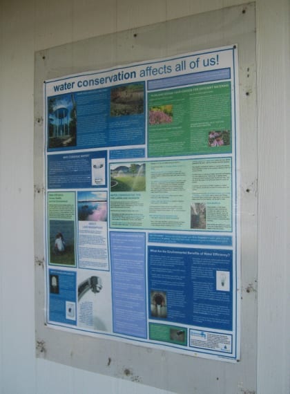 A new poster on the bath house wall provides conservation information.